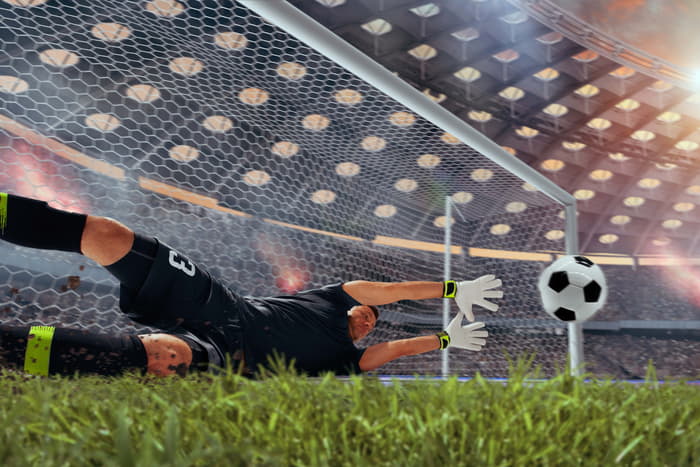 Piros lap és büntető fogadás - kapus éppen büntetőt hárít